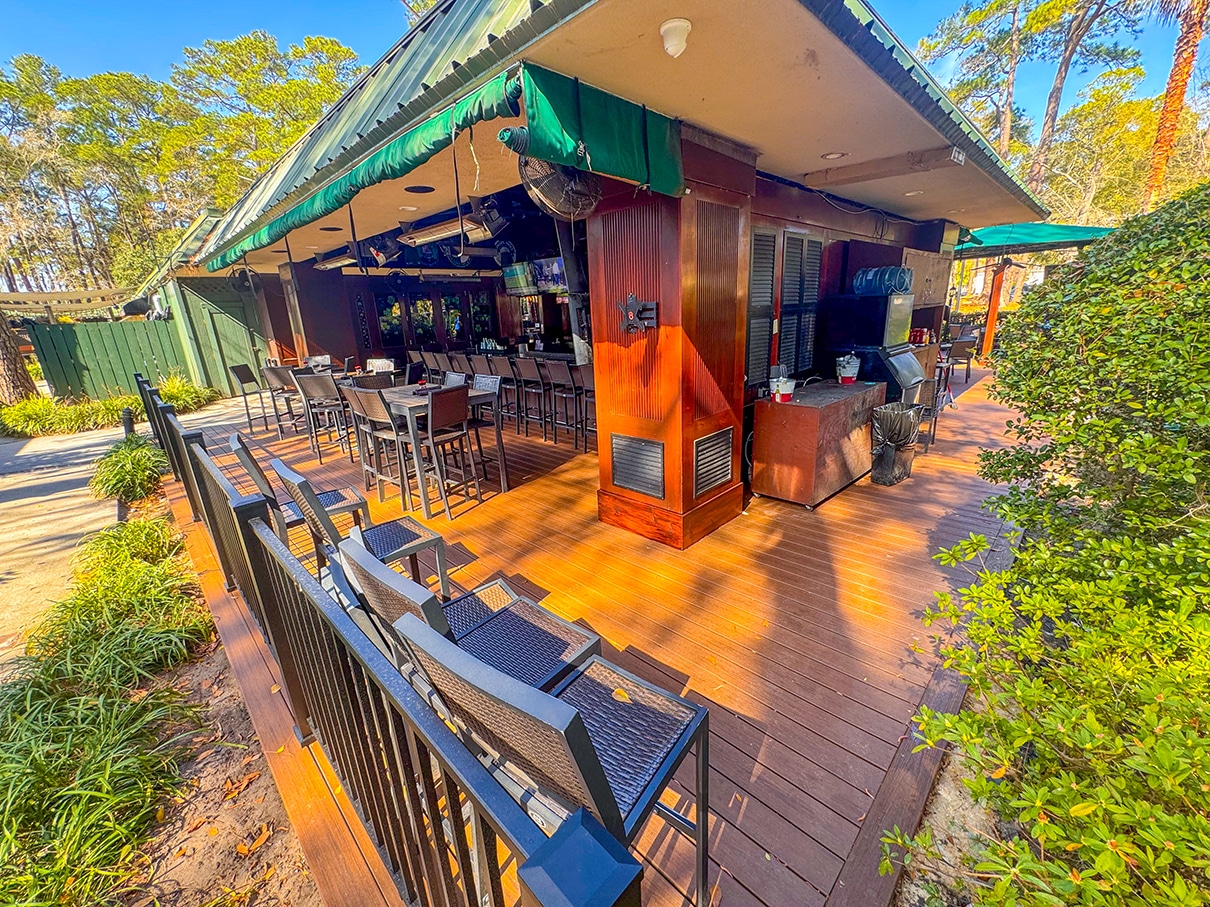 High-angle shot of black dining tables and chairs arranged on the new deck.
